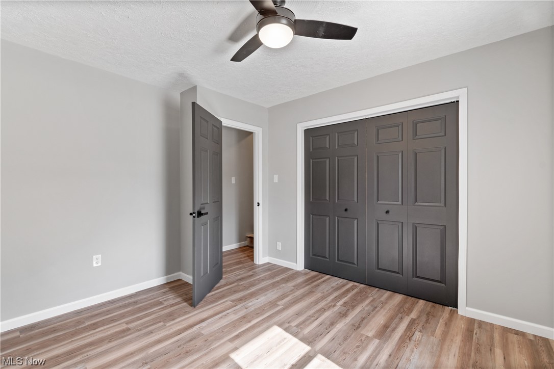 59636 Broadview Road Shadyside, OH 43947 - Photo 25 of 31 Unfurnished bedroom with a textured ceiling, ceiling fan, a closet, and light hardwood flooring