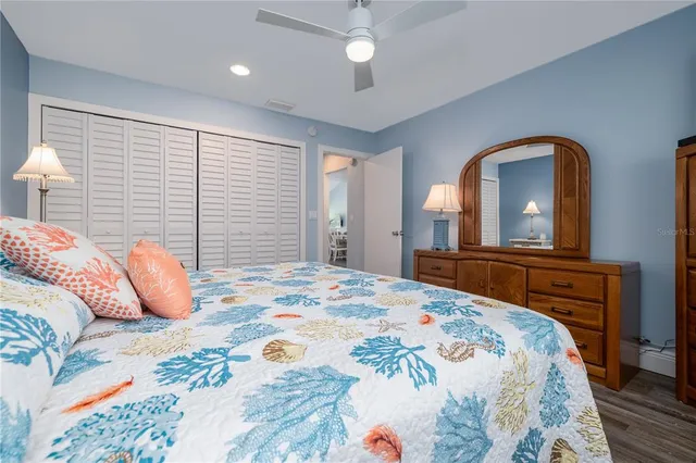 a bedroom with a large bed and a chandelier