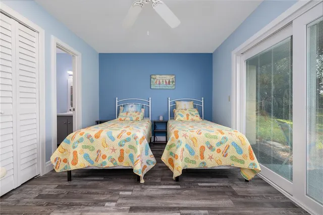 a bedroom with two beds and a wooden floor