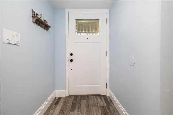 a view of a small space with wooden floor and a window
