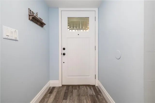 a view of a small space with wooden floor and a window