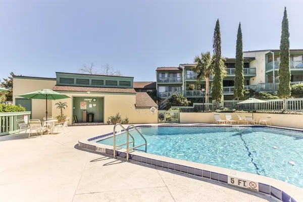a swimming pool with outdoor seating and yard