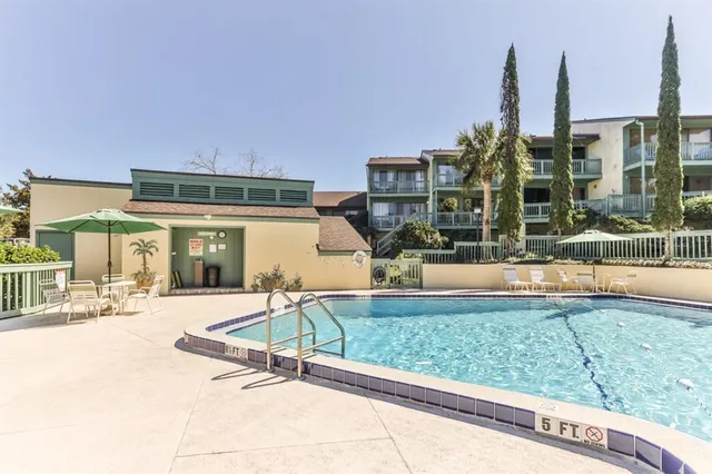 a swimming pool with outdoor seating and yard