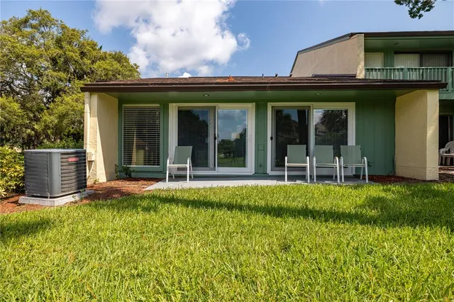a view of a house with sitting area and garden