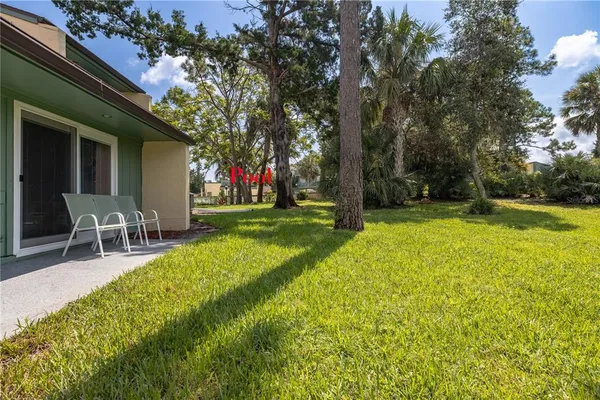 a view of a house with a backyard