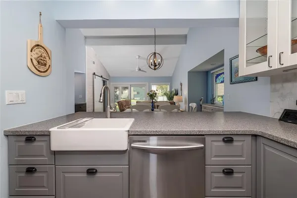 a kitchen with a sink and a clock on the wall