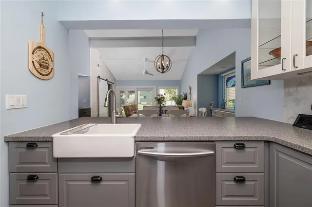 a kitchen with a sink and a clock on the wall