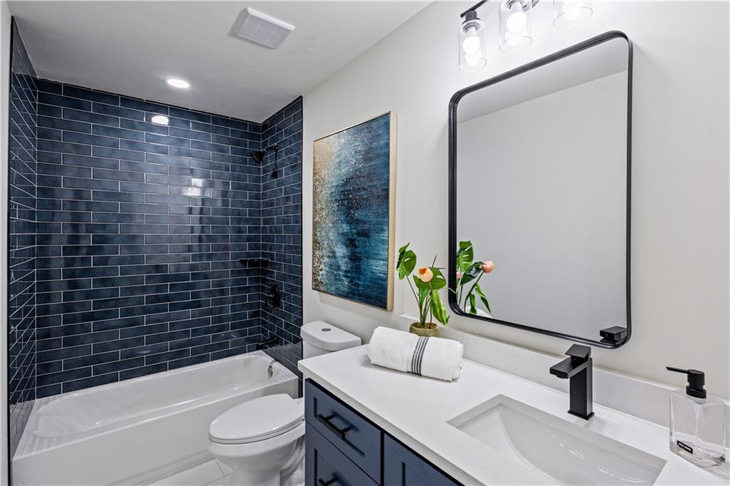 3252 Pinehill Drive Decatur, GA 30032 - Photo 13 of 26 a bathroom with a granite countertop bathtub sink vanity mirror and toilet