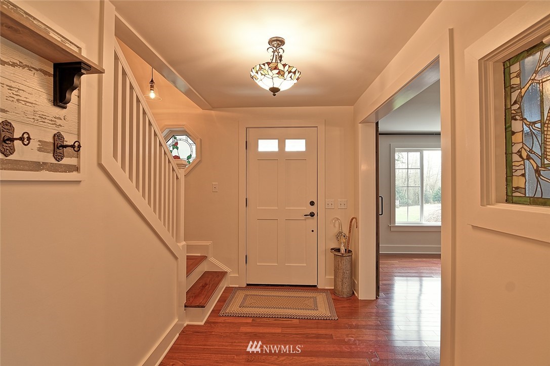 5918 Robe Menzel Road Snohomish, WA 98290 - Photo 12 of 40 a view of a hallway with wooden floor and a living room