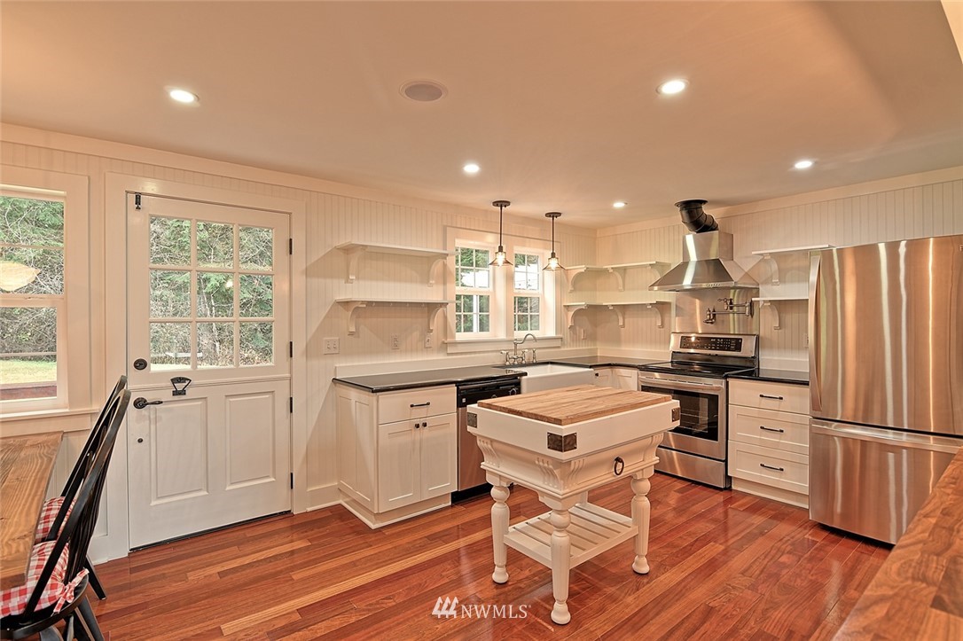 5918 Robe Menzel Road Snohomish, WA 98290 - Photo 13 of 40 a kitchen with white cabinets and stainless steel appliances