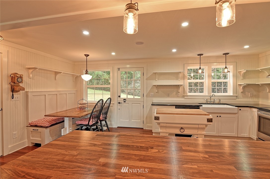 5918 Robe Menzel Road Snohomish, WA 98290 - Photo 14 of 40 a large white kitchen with a large window a counter space and a view of dining room