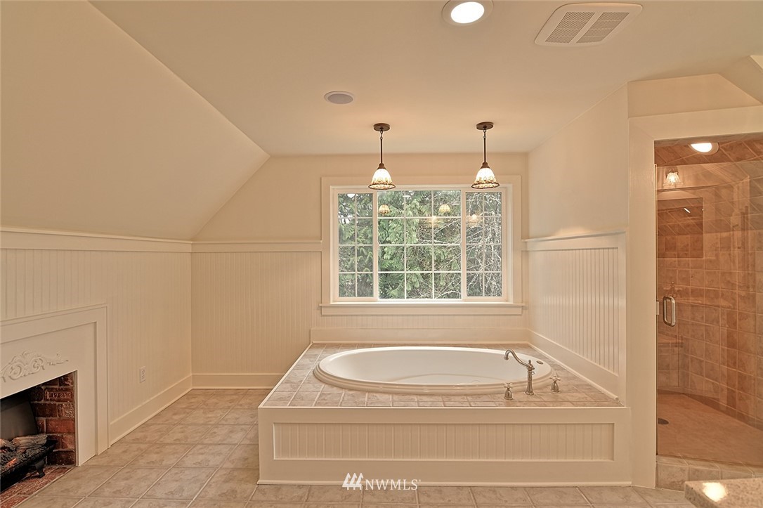 5918 Robe Menzel Road Snohomish, WA 98290 - Photo 24 of 40 a bathroom with a tub a window and a shower