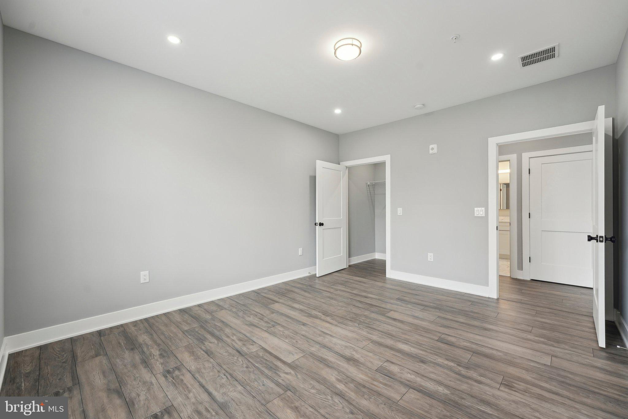 2421 Bristol Road, Unit 310 Warrington, PA 18976 - Photo 14 of 19 a view of an empty room with wooden floor