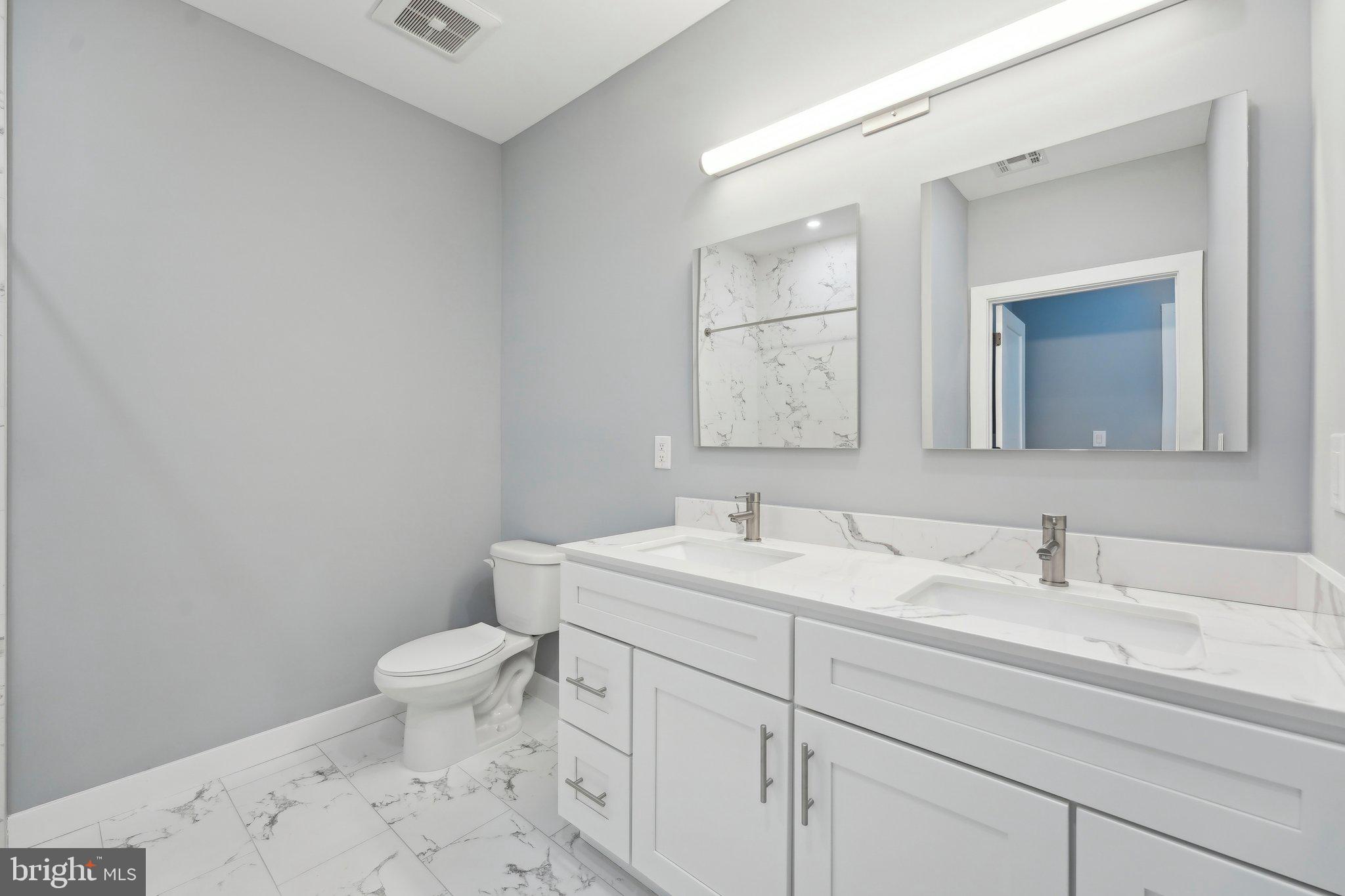 2421 Bristol Road, Unit 310 Warrington, PA 18976 - Photo 15 of 19 a bathroom with a toilet sink and mirror