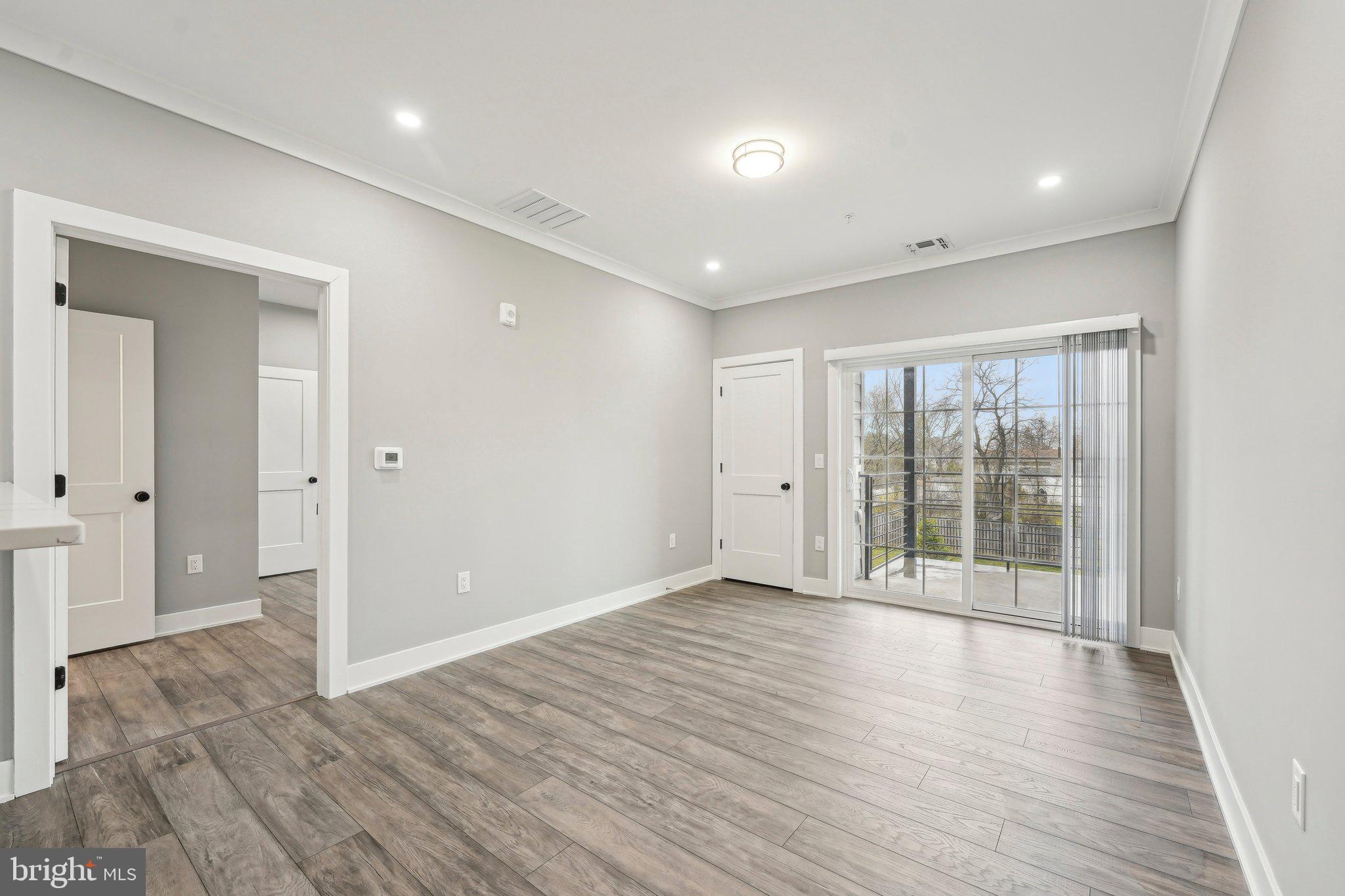 2421 Bristol Road, Unit 310 Warrington, PA 18976 - Photo 7 of 19 an empty room with wooden floor and windows
