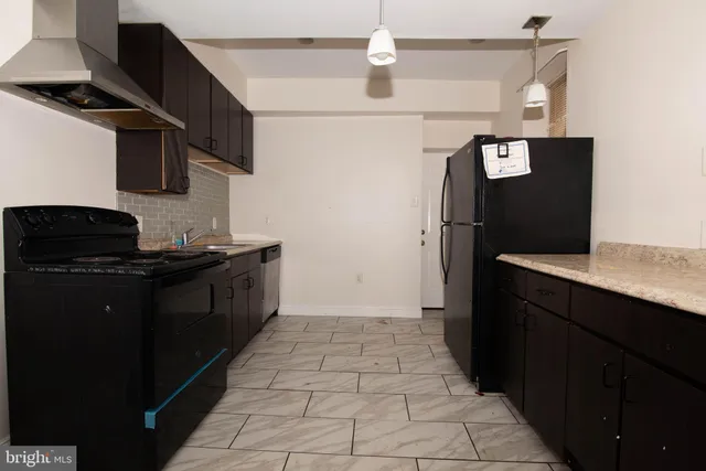a kitchen with a refrigerator and a stove