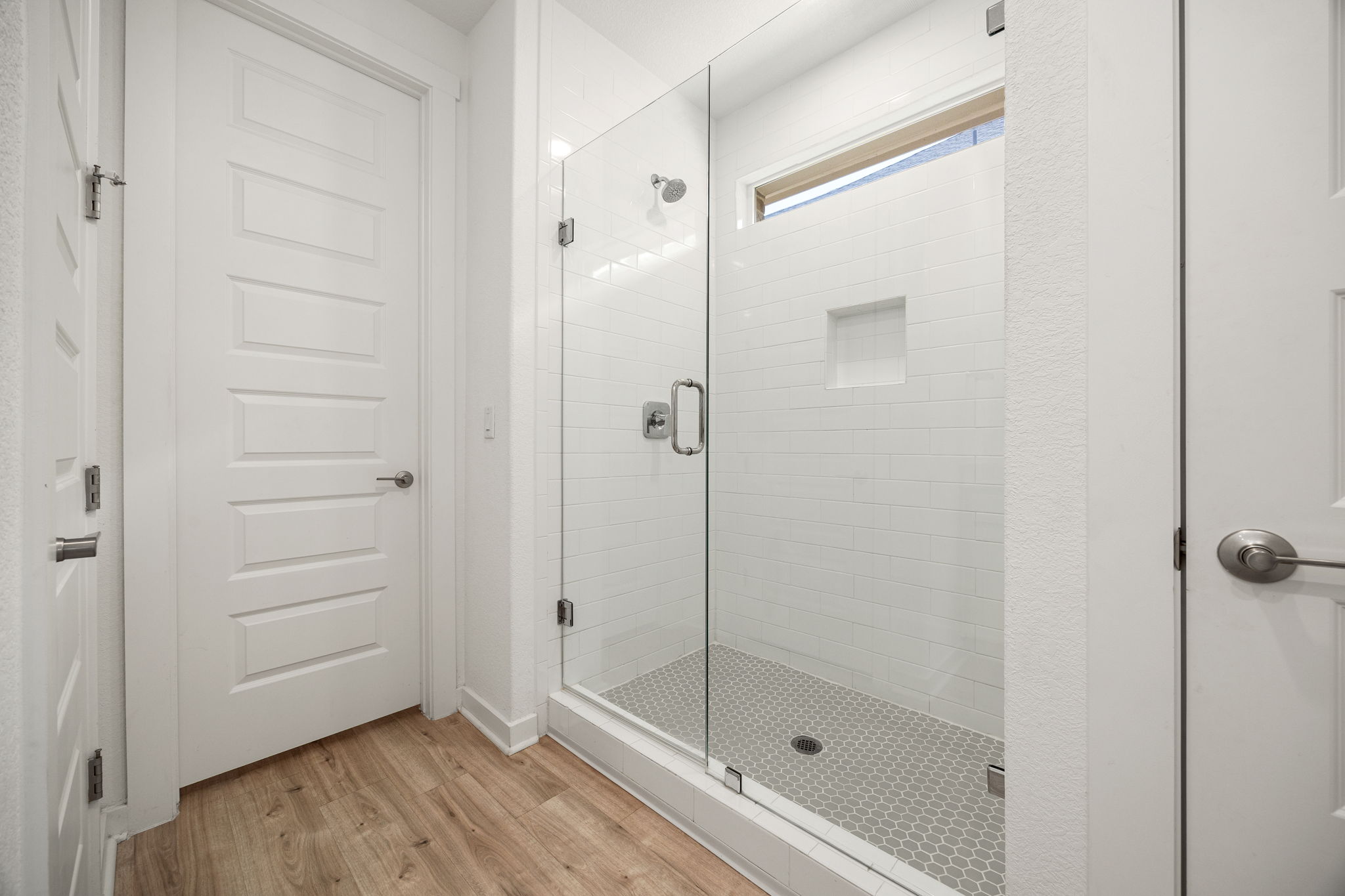 904 Balsora Cove Georgetown, TX 78628 - Photo 22 of 40 Bathroom with a frameless stall shower and wood-like vynil flooring