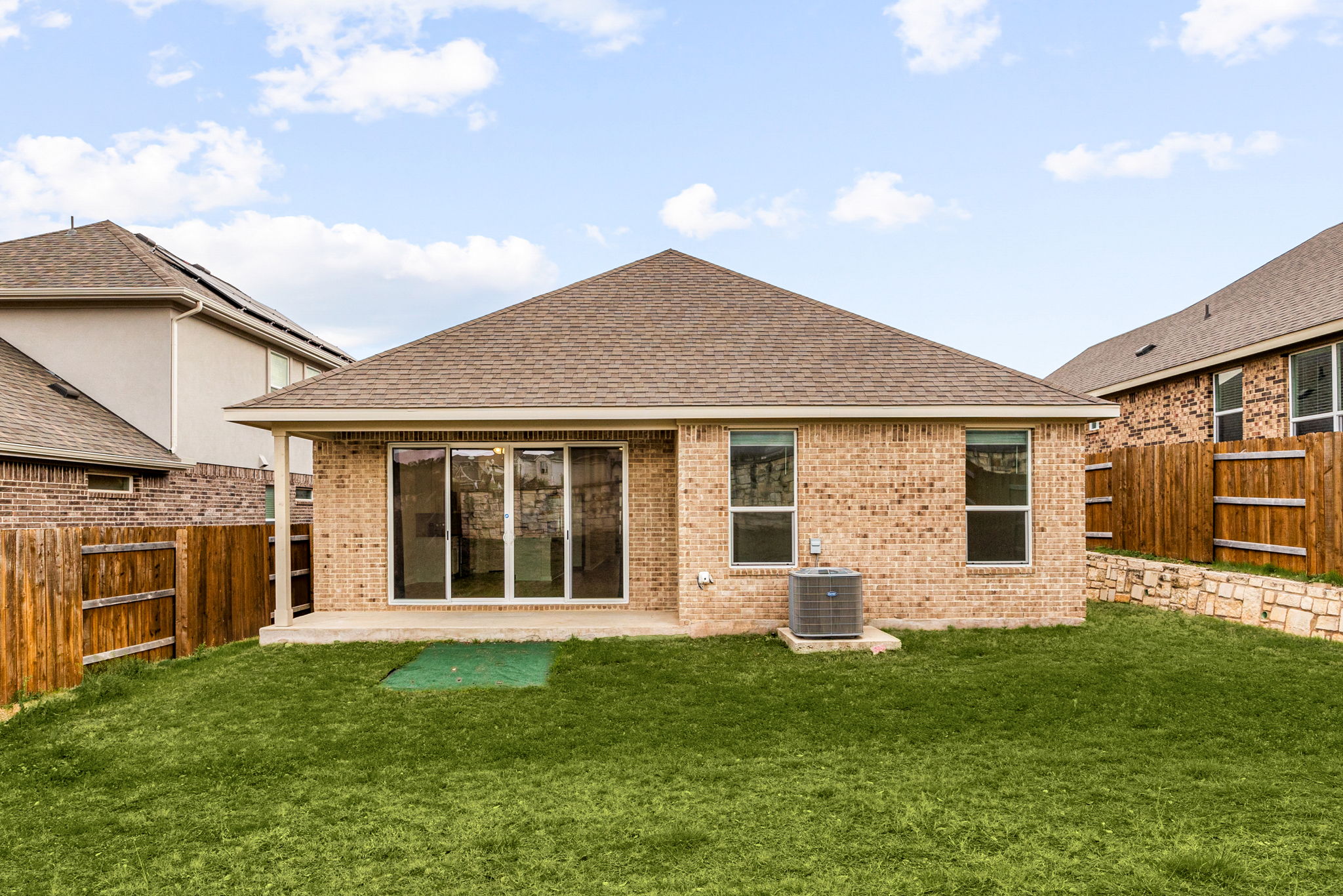 904 Balsora Cove Georgetown, TX 78628 - Photo 35 of 40 Rear view of property featuring a coverd patio, roof with shingles, brick siding, and a fenced backyard