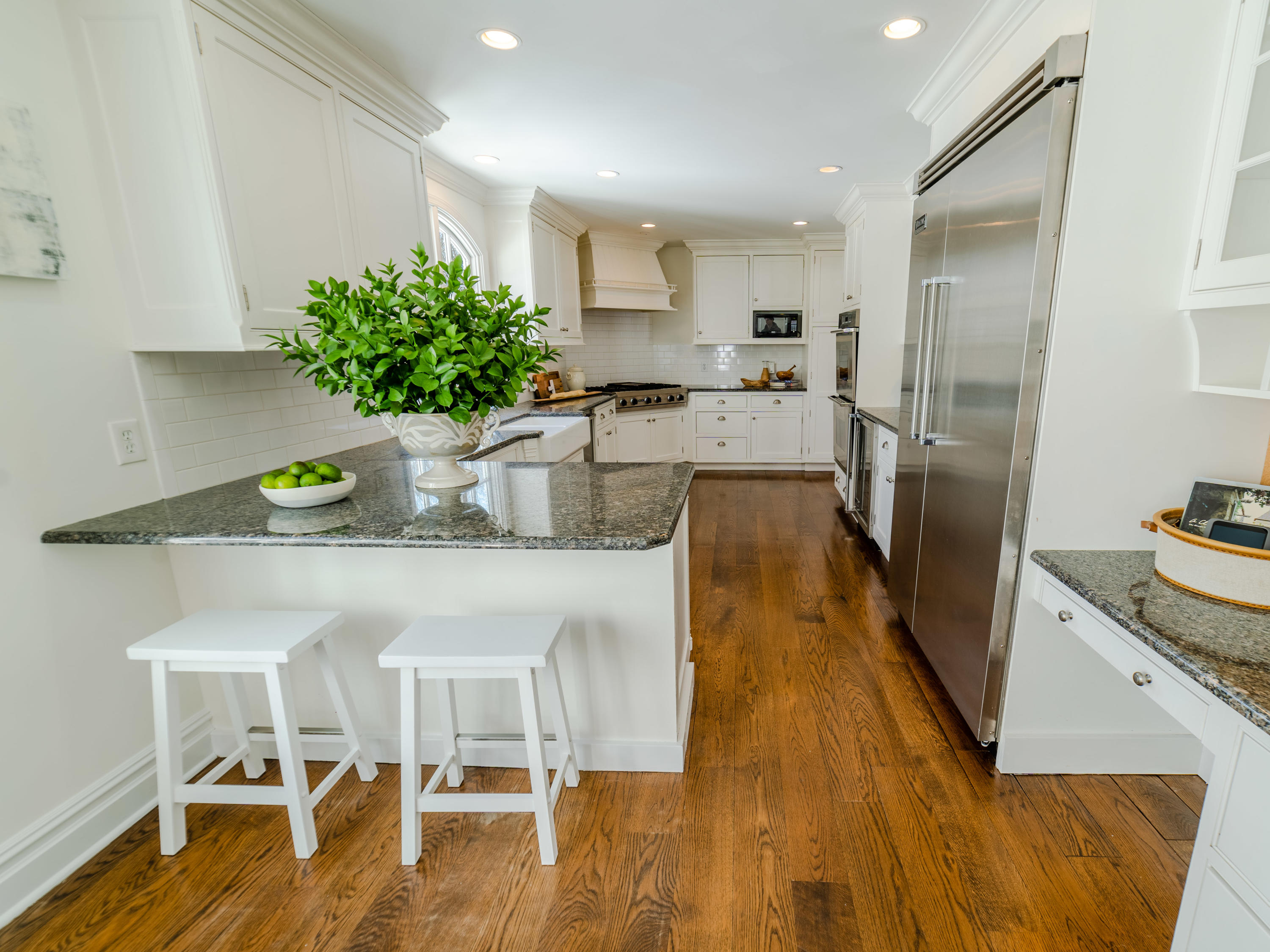 103 Salem Road New Canaan, CT 06840 - Photo 13 of 42 a kitchen with stainless steel appliances granite countertop a refrigerator a sink a stove and white cabinets