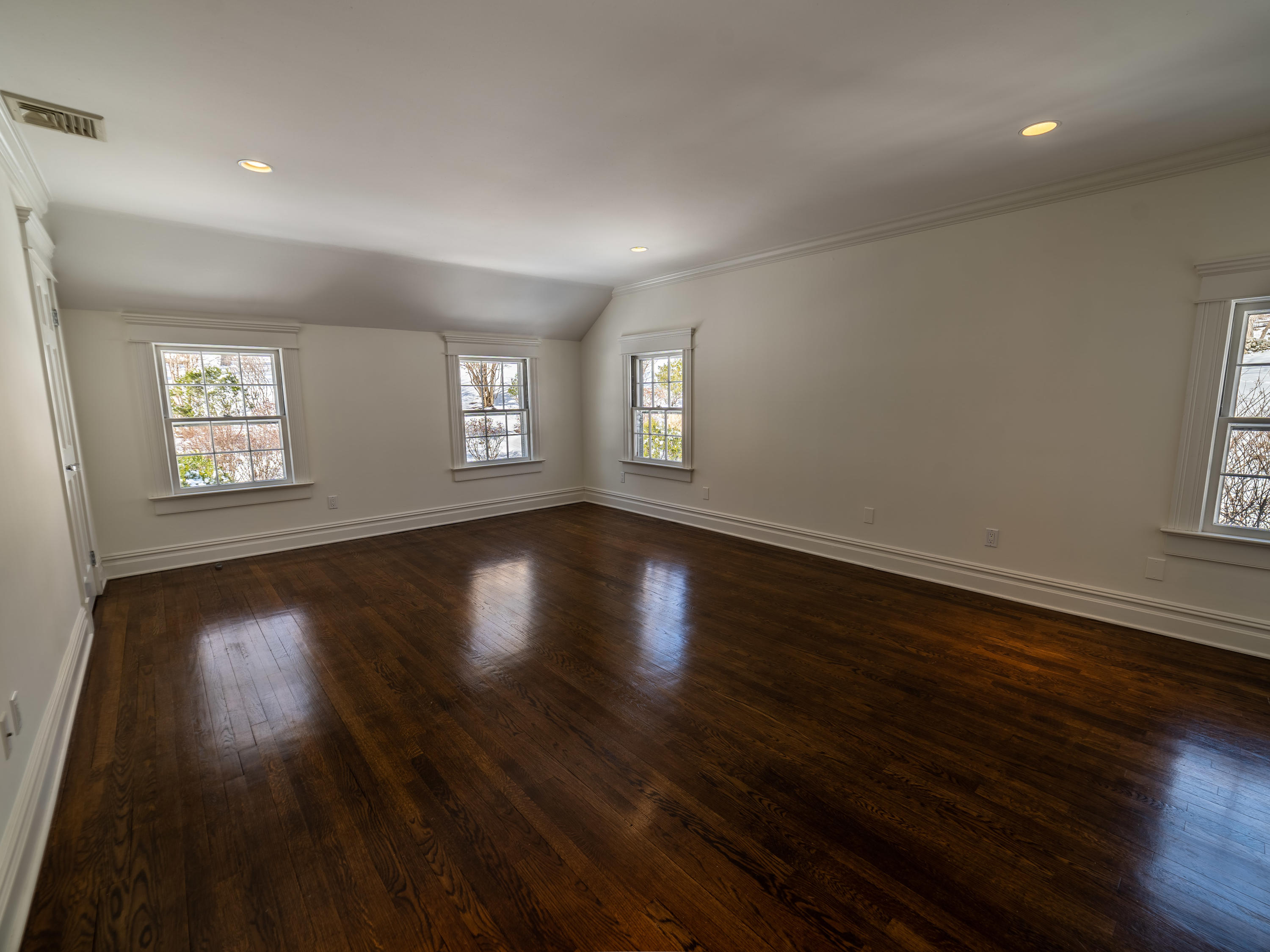 103 Salem Road New Canaan, CT 06840 - Photo 18 of 42 a view of an empty room with wooden floor and windows