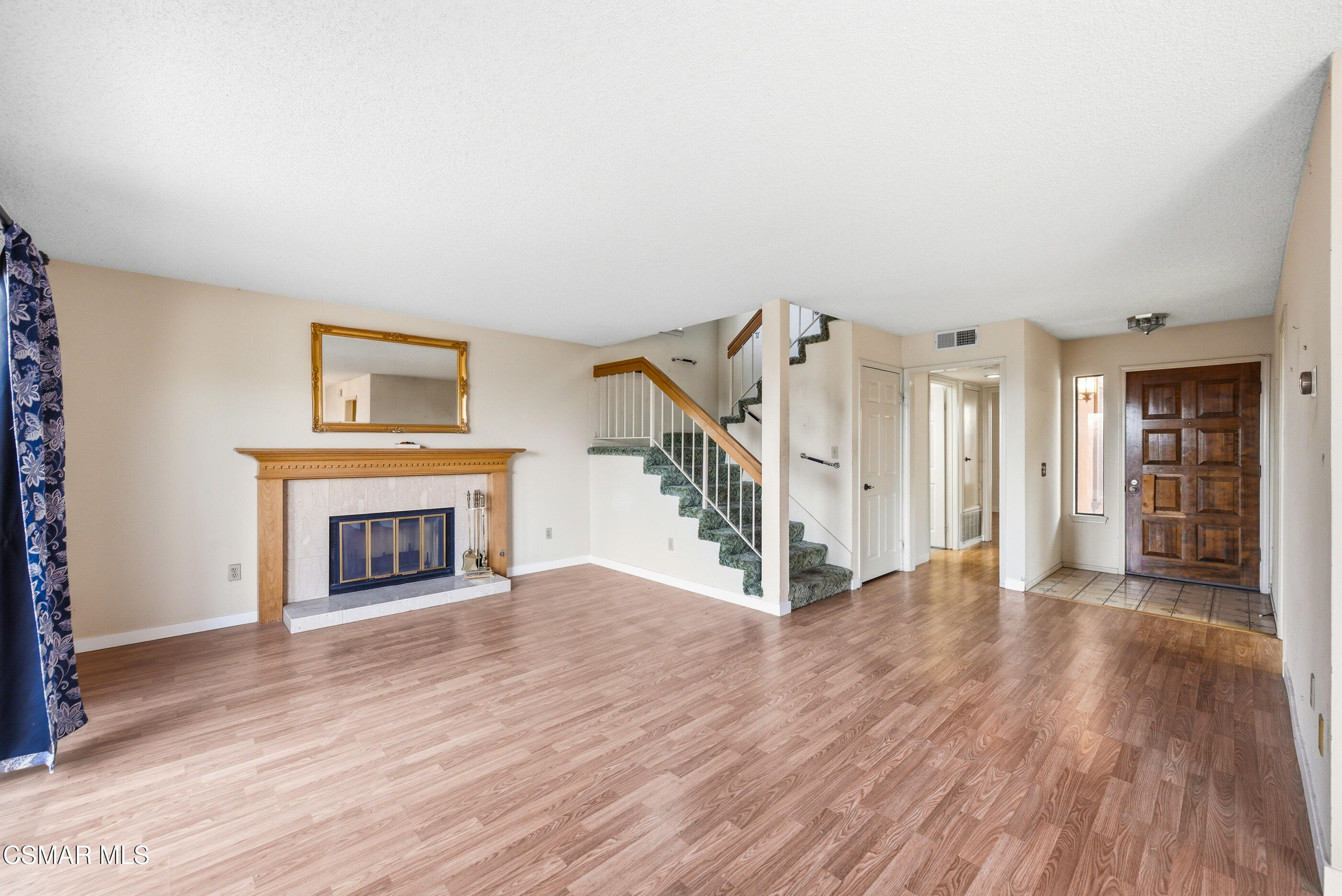 12036 Shadow Ridge Way Porter Ranch, CA 91326 - Photo 4 of 35 a view of a livingroom with wooden floor and a fireplace