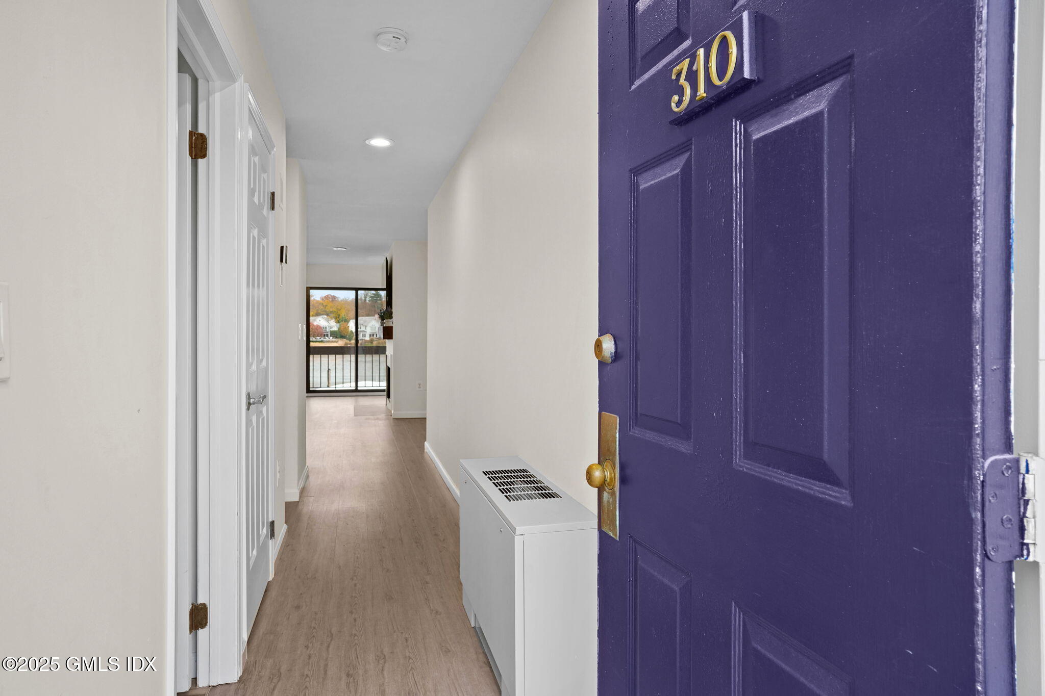 7 River Road, Unit 310 Cos Cob, CT 06807 - Photo 2 of 19 a view of a hallway with wooden floor