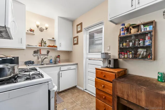 a kitchen with stainless steel appliances granite countertop a stove and a refrigerator