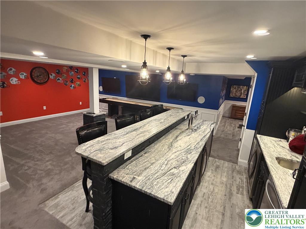 4157 Walter Road Bethlehem, PA 18020 - Photo 35 of 36 A vibrant entertainment zone featuring a fully equipped wet bar with natural stone countertops.