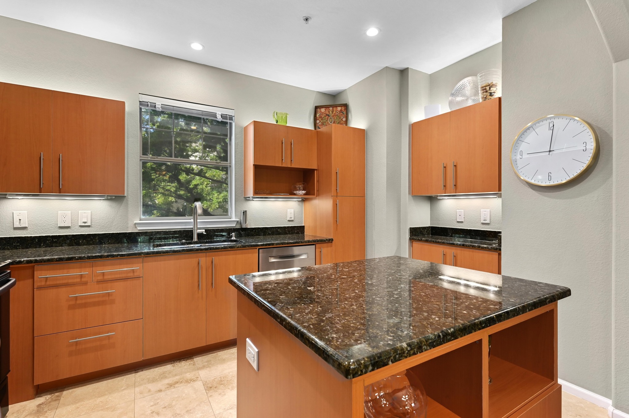 11203 Ranch Road 2222, Unit 1104 Austin, TX 78732 - Photo 11 of 23 Kitchen with granite counters, stainless appliances and center island and open shelves.