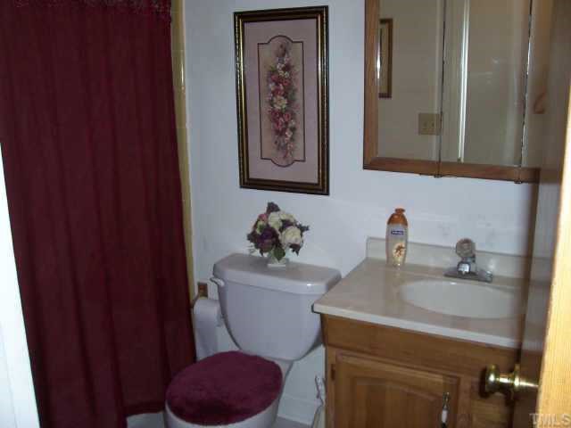 6503 Whitt Road Durham, NC 27712 - Photo 8 of 10 a bathroom with a toilet a sink and mirror