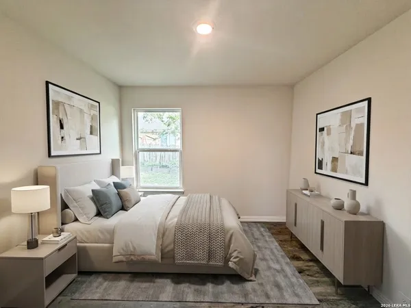 a bedroom with bed and night stand