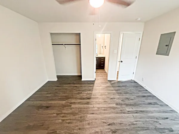 a view of a room with wooden floor and a hallway