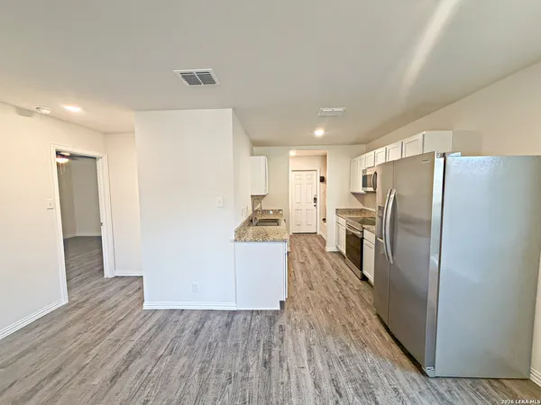 a kitchen with a refrigerator freezer and a dishwasher