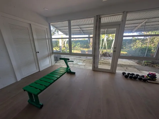 a room with pool table and a large window
