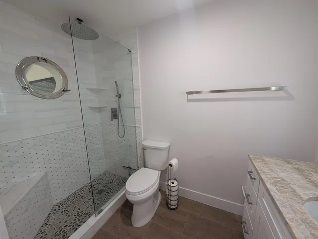 a bathroom with a toilet and a shower