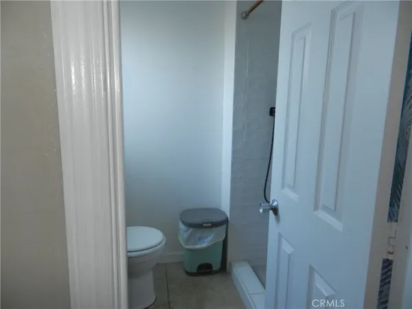 a bathroom with a granite countertop toilet and a sink