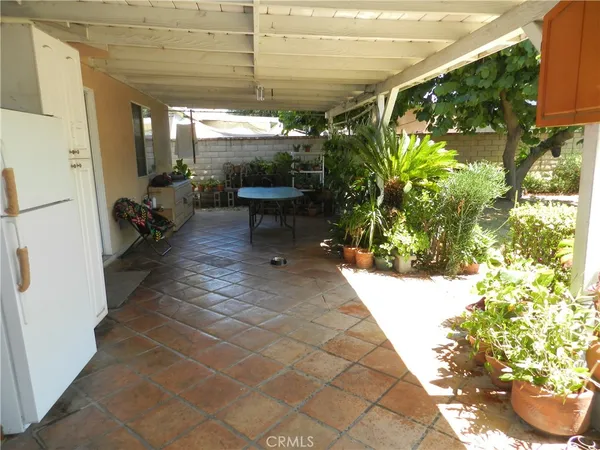 a view of a patio with table and chairs and potted plants