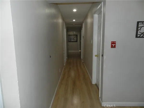 a view of hallway with wooden floor