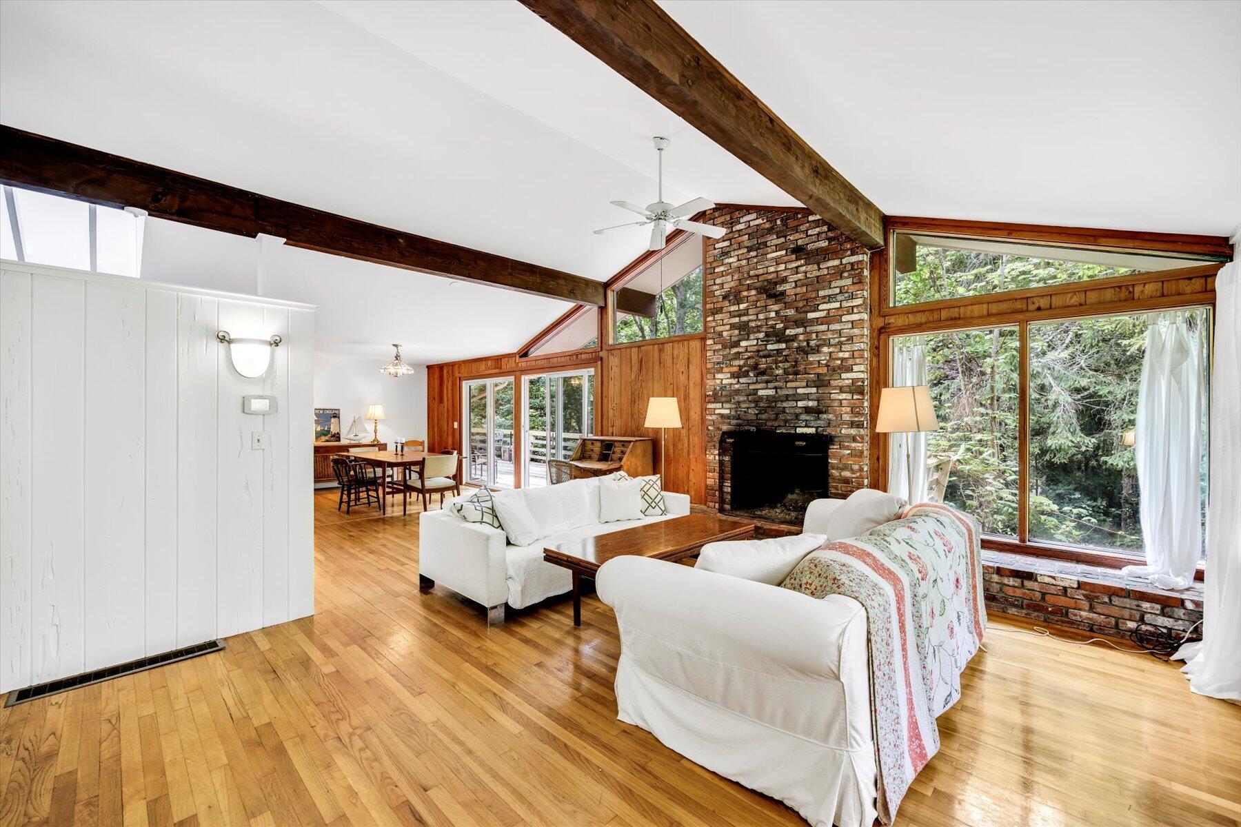 44 Nobska Road Woods Hole, MA 02543 - Photo 30 of 47 a living room with furniture large window and a fireplace