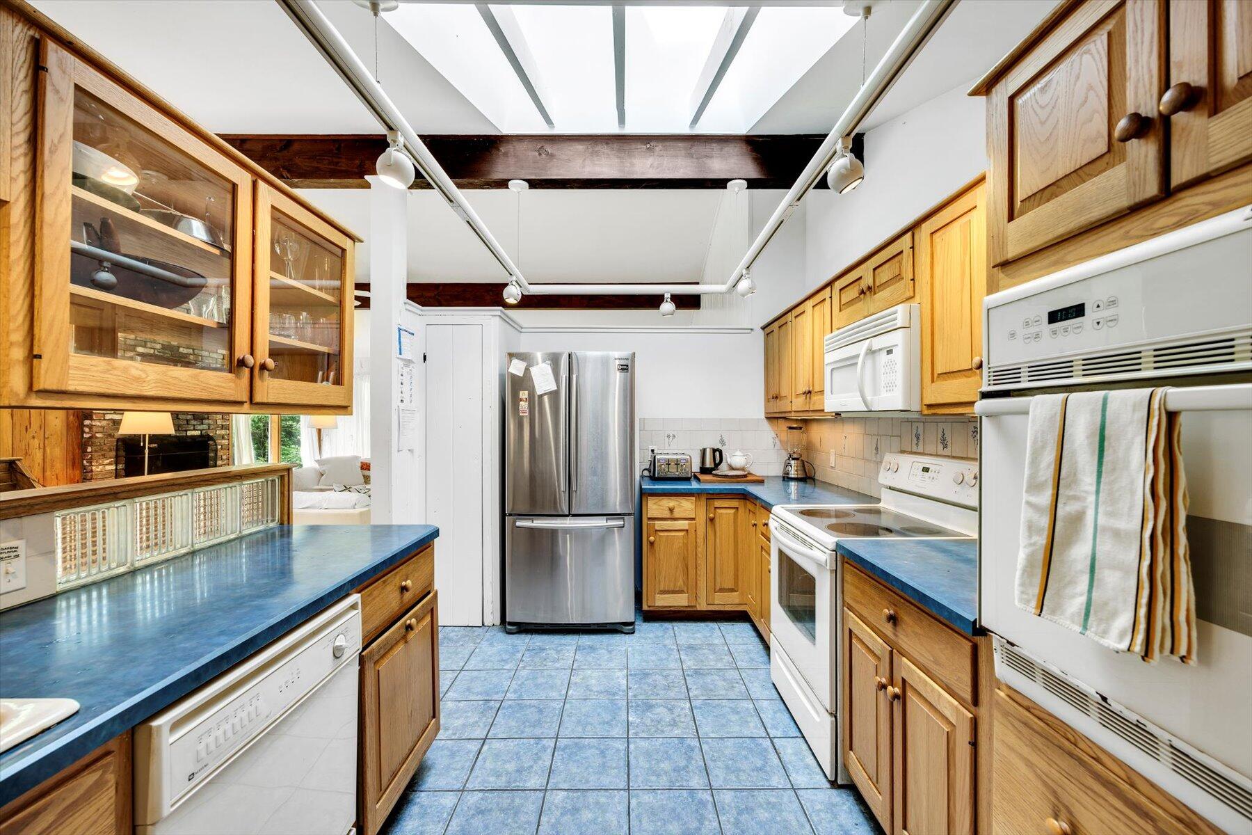 44 Nobska Road Woods Hole, MA 02543 - Photo 36 of 47 a kitchen with stainless steel appliances granite countertop a refrigerator a stove and a sink