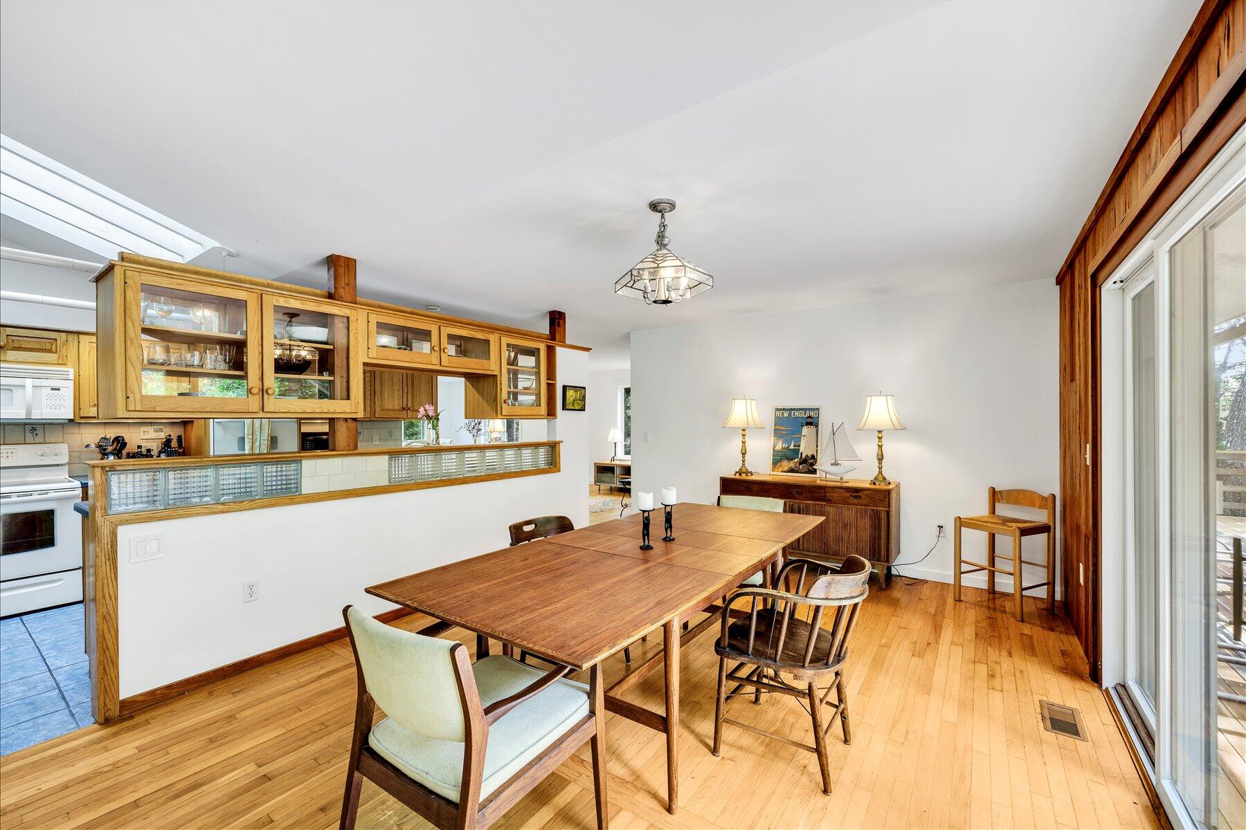 44 Nobska Road Woods Hole, MA 02543 - Photo 45 of 47 a dining hall with stainless steel appliances granite countertop a dining table and chairs with wooden floor