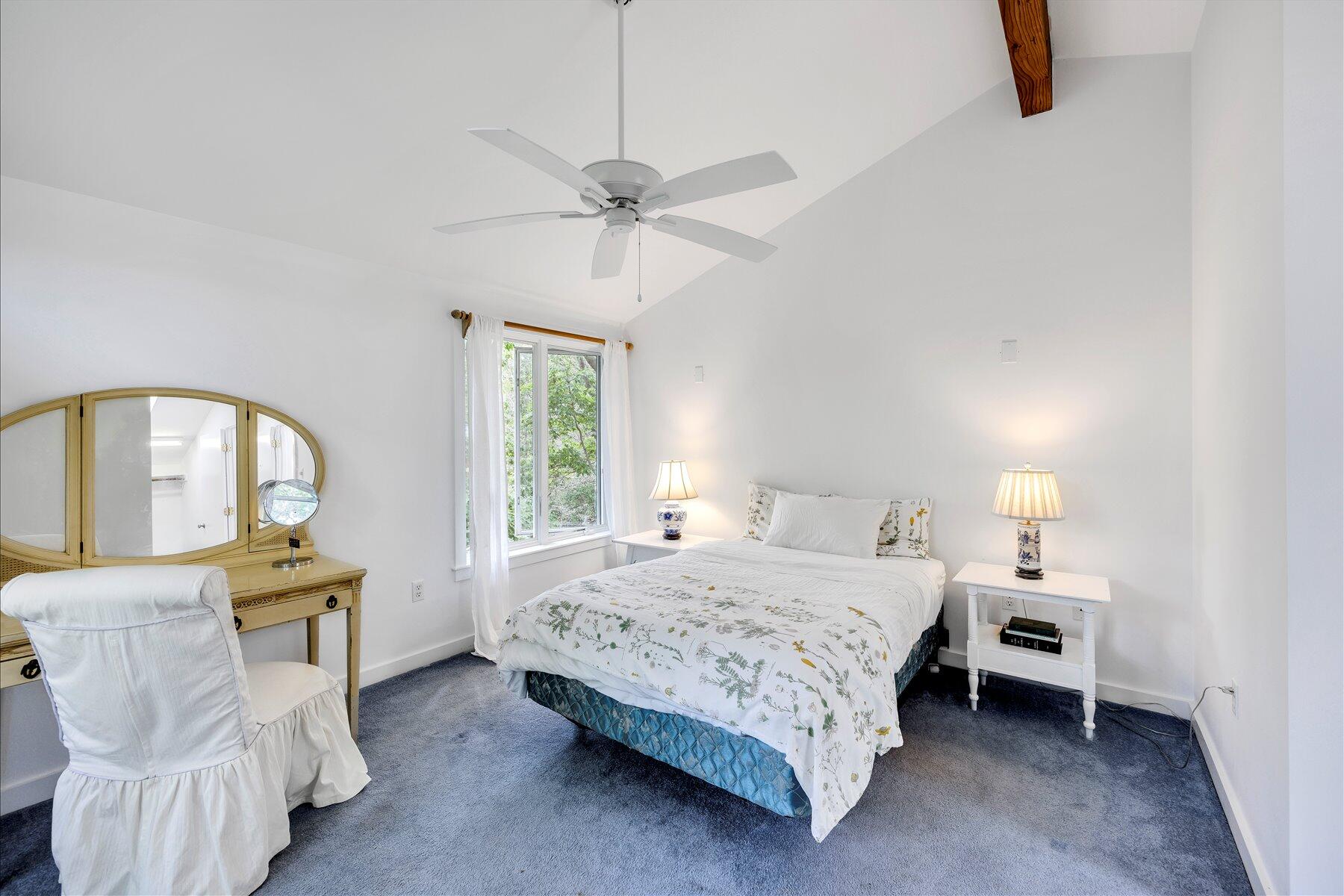 44 Nobska Road Woods Hole, MA 02543 - Photo 8 of 47 a bedroom with a bed and a chandelier