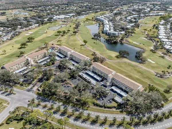 an aerial view of a house with garden space and street view