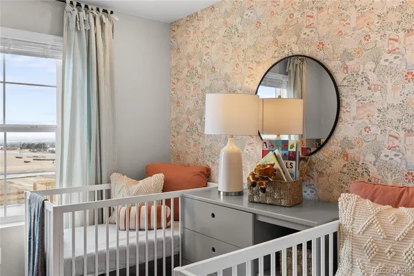 a bedroom with a bed a mirror and a window