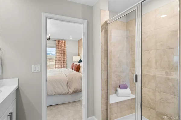 a spacious bathroom with a shower sink and mirror