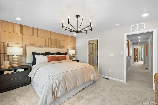 a bedroom with a bed and a chandelier