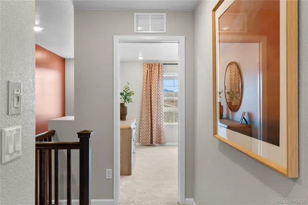 a view of a hallway with paintings on the wall