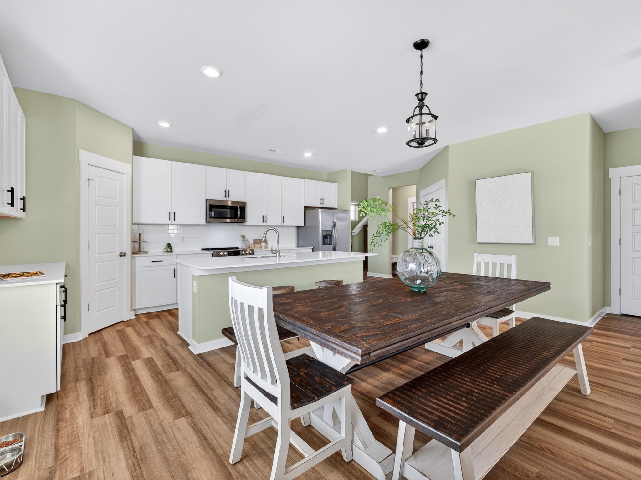 145 Southwind Run Spring Hill, TN 37174 - Photo 13 of 62 a dinning room dining table chairs wooden floor and a kitchen view