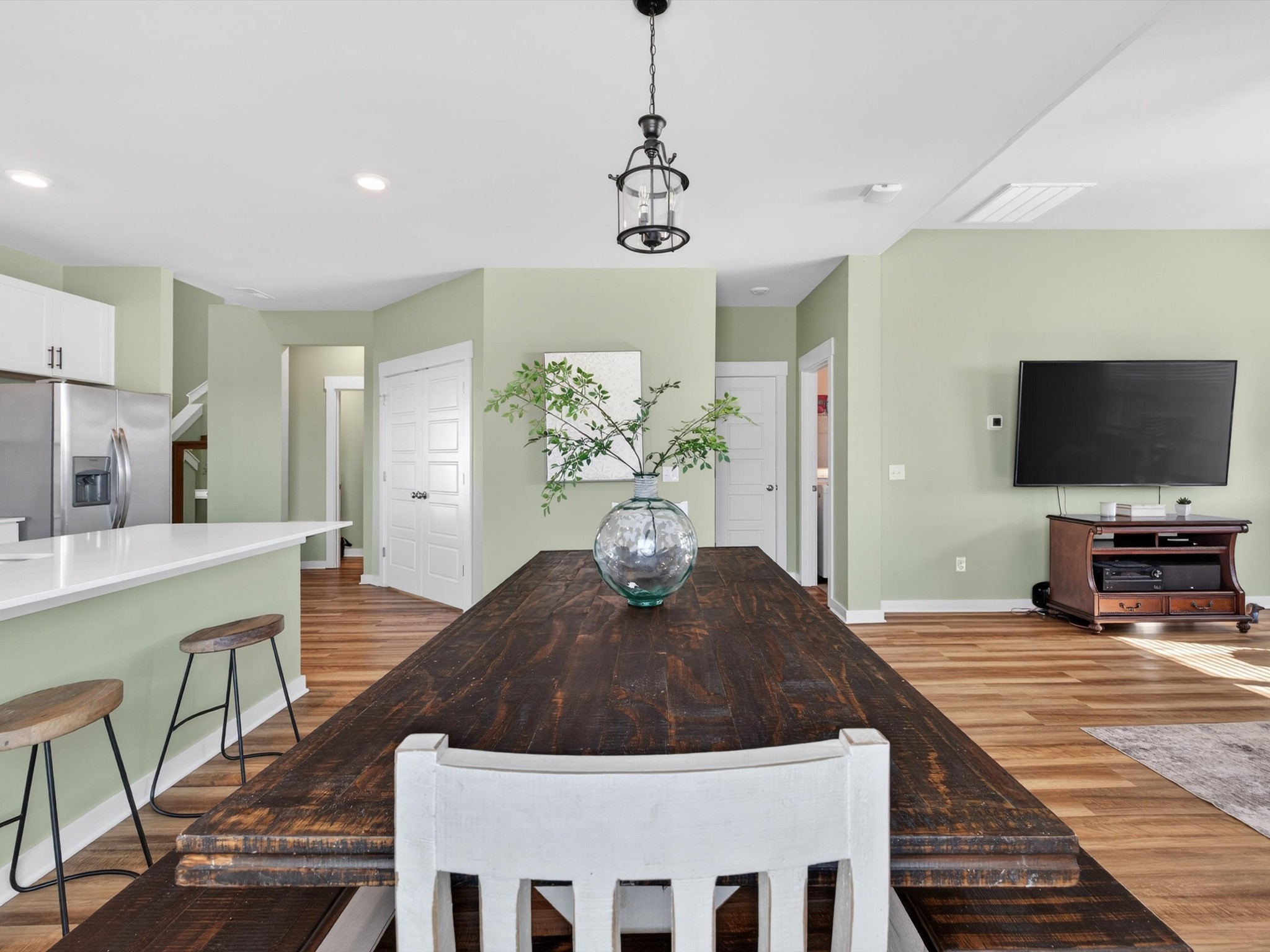 145 Southwind Run Spring Hill, TN 37174 - Photo 14 of 62 a living room with stainless steel appliances furniture a chandelier and a flat screen tv