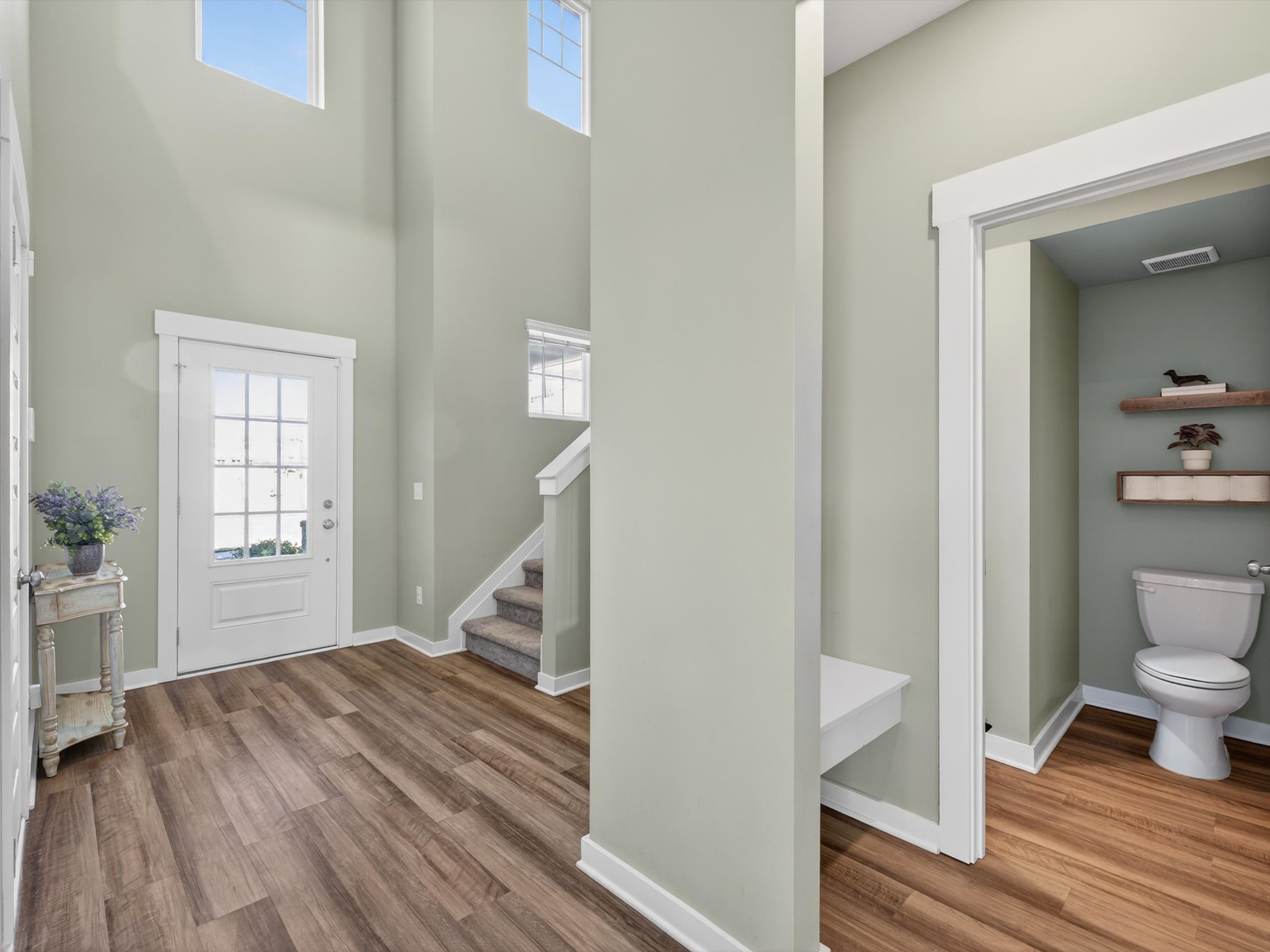 145 Southwind Run Spring Hill, TN 37174 - Photo 6 of 62 a view of a hallway with wooden floor and staircase